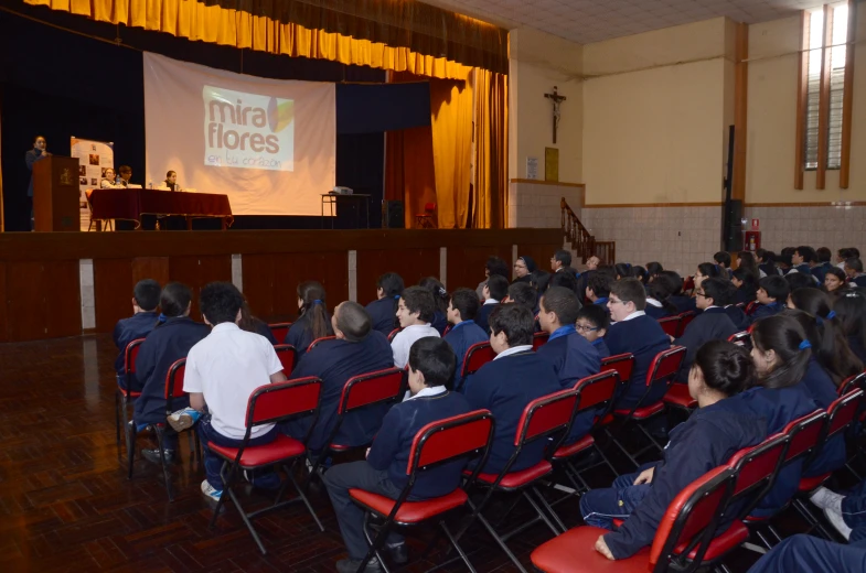 a class is shown with an audience in chairs