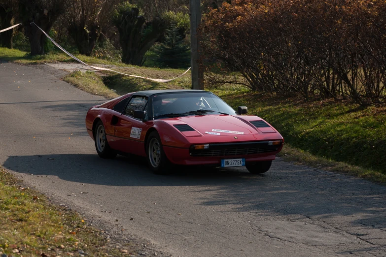 a car sitting on the side of a road near trees