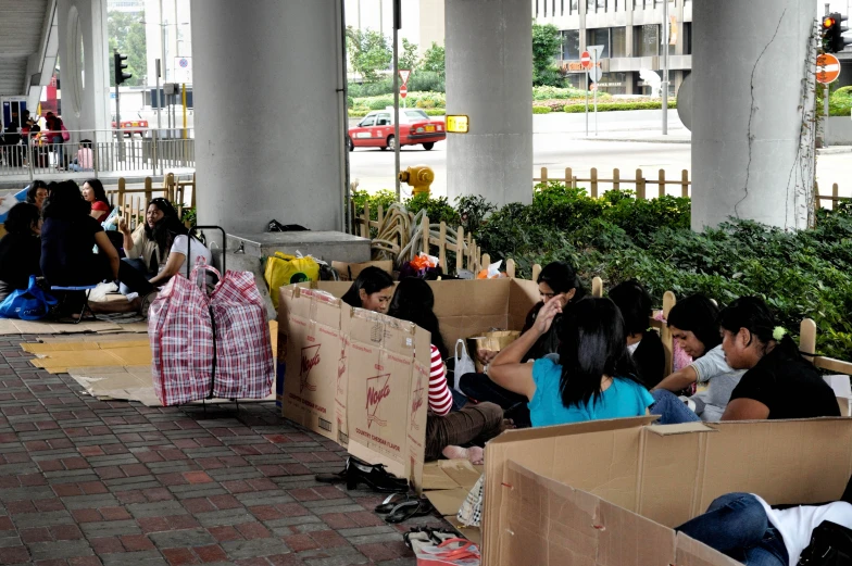 a group of people sitting inside of cardboard boxes
