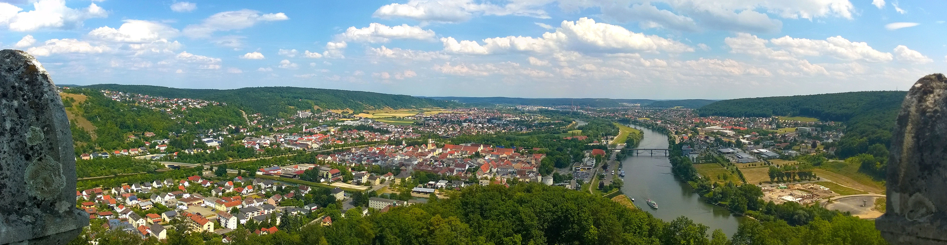 an overlook looking down on the valley and river from the rock wall