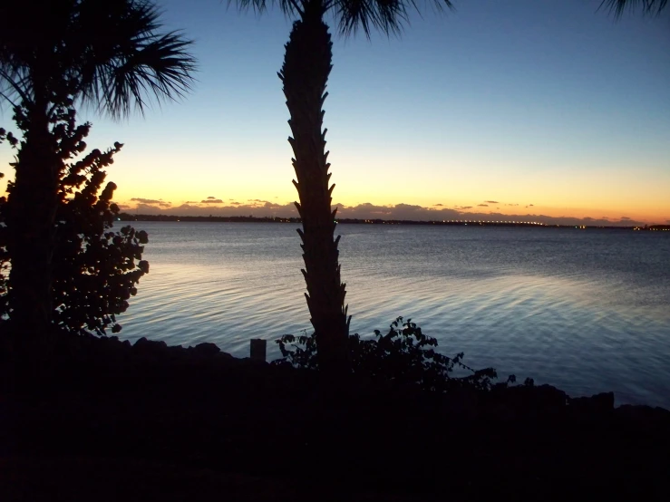 the sun setting over a body of water