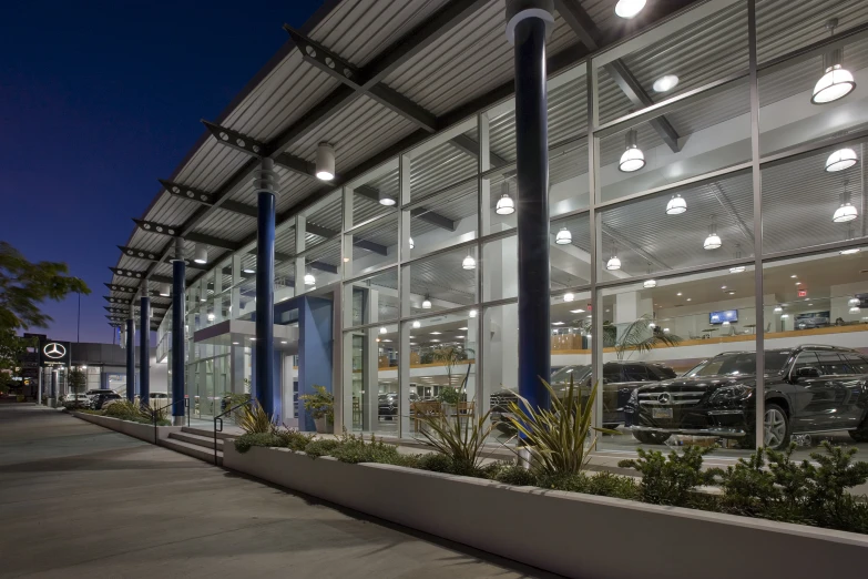 a long concrete planter on a city street at night