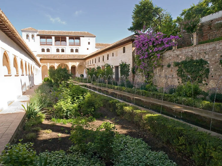 a courtyard with water fountains next to buildings