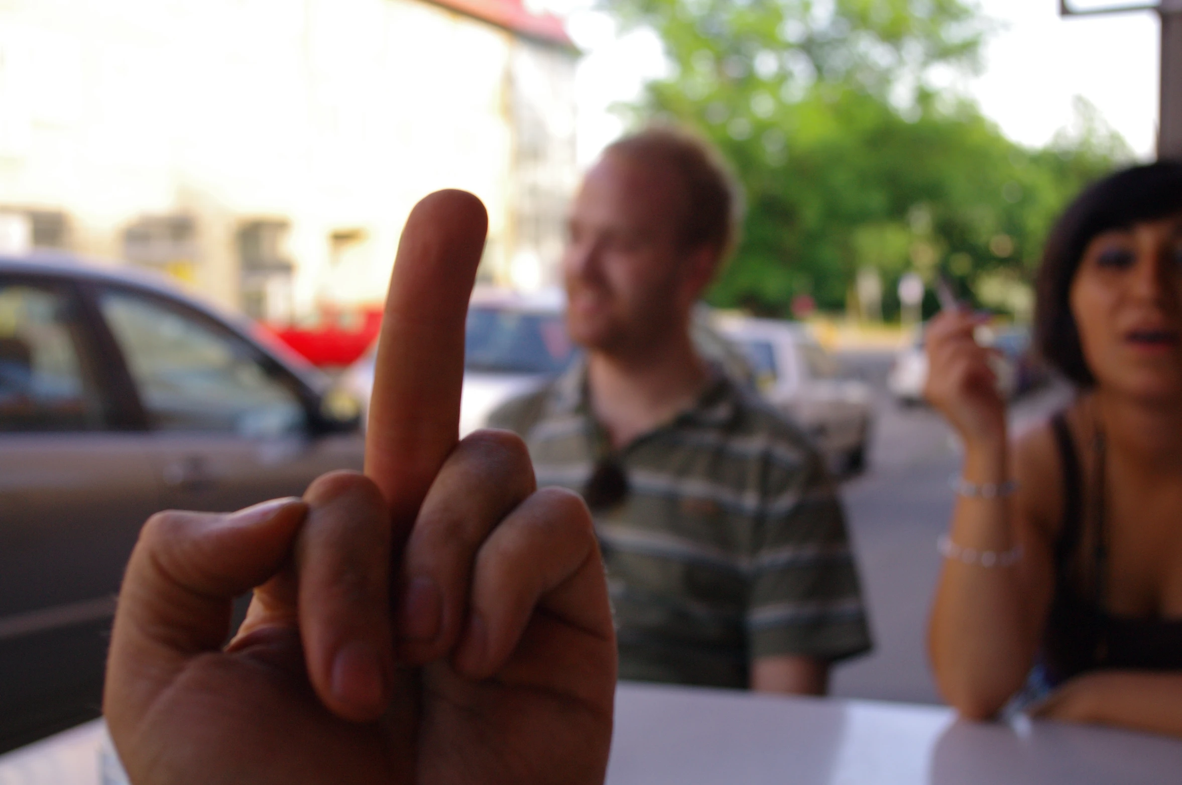 a couple is sitting at a table eating pizza