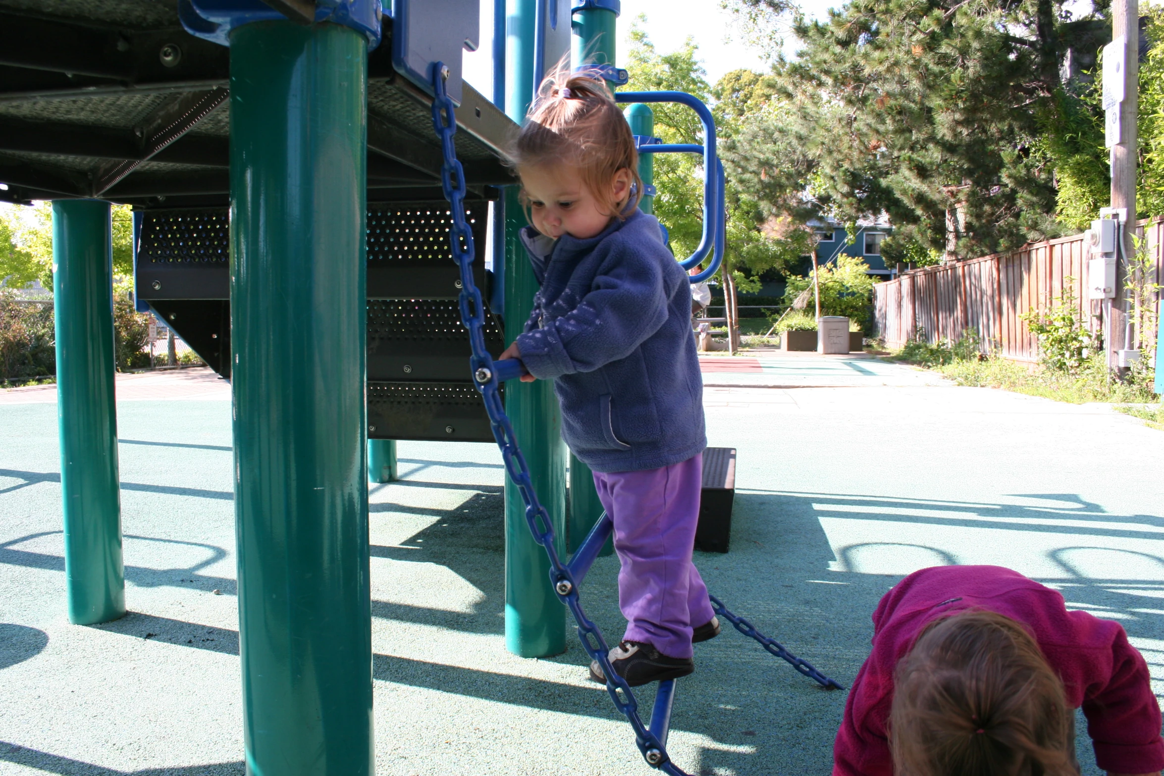 a child plays on the swing set in a playground