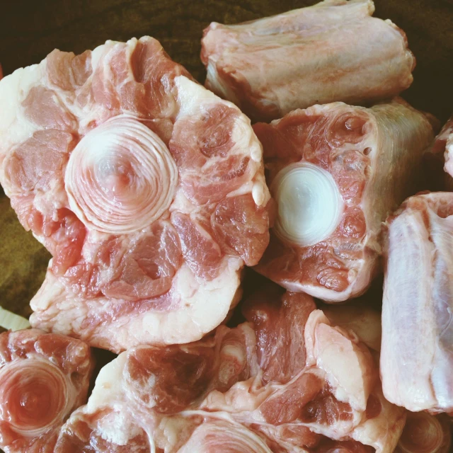 a close up of raw meat in a bowl