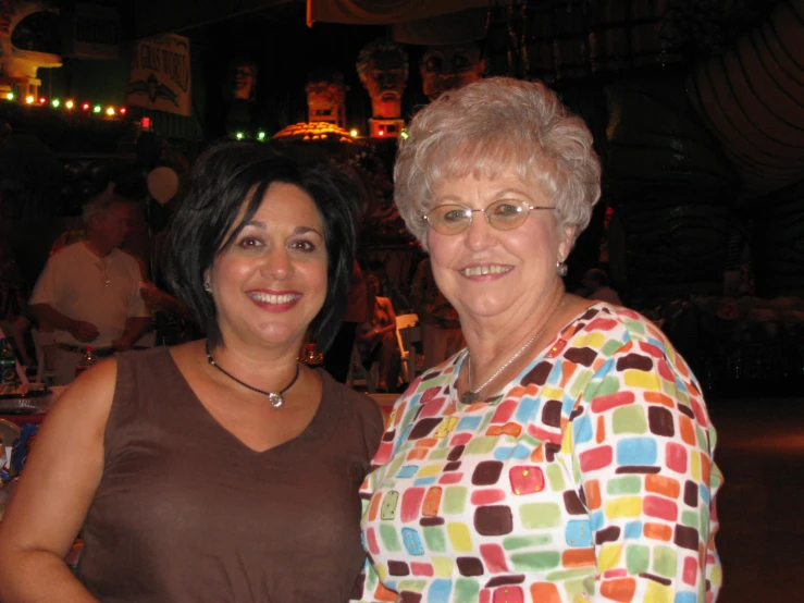 two women pose for a po in a brightly colored restaurant