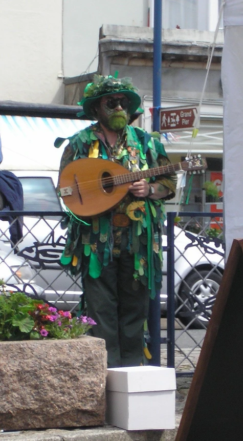 a man in costume playing an acoustic guitar