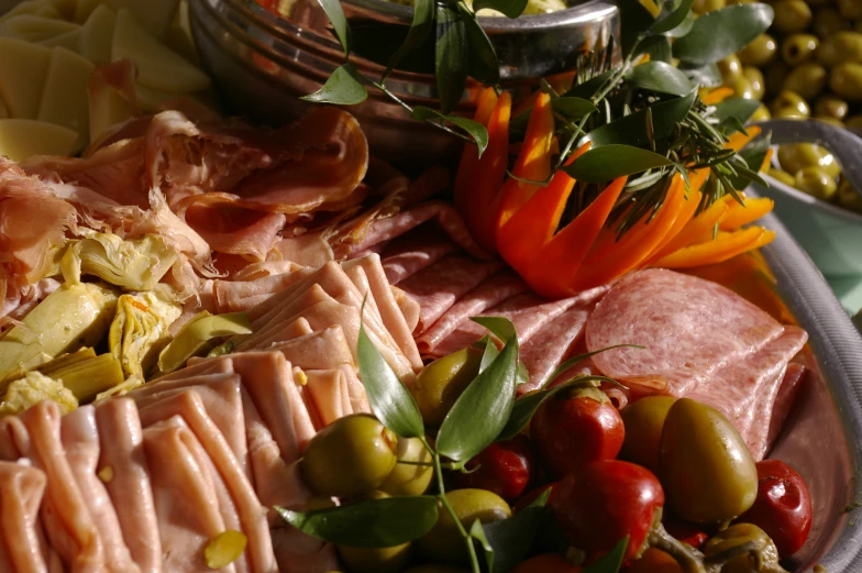 many vegetables and meats are displayed in bowls