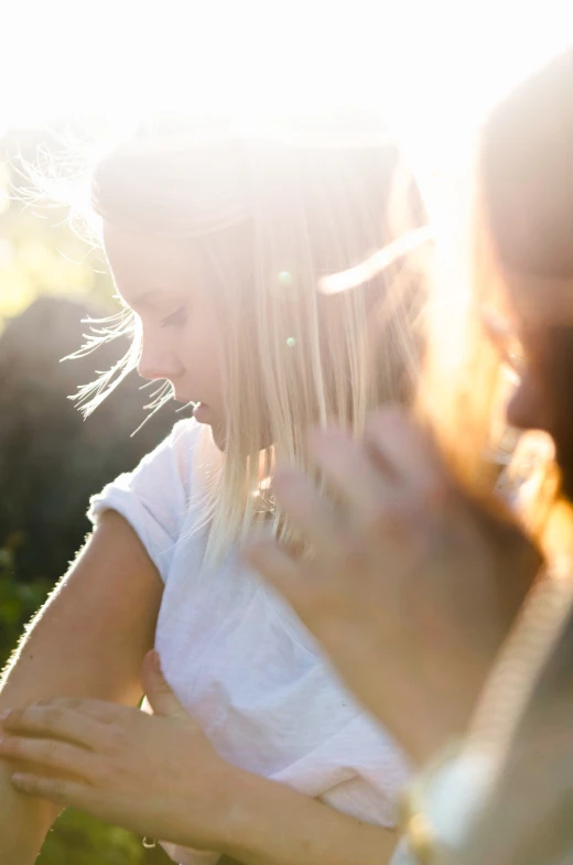 an adult helping a  hold a cellphone