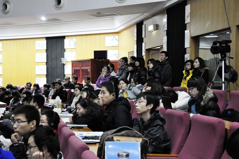 a large audience at the conference room with lots of people