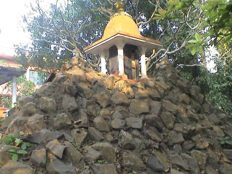 a yellow and white tower on top of a rock pile