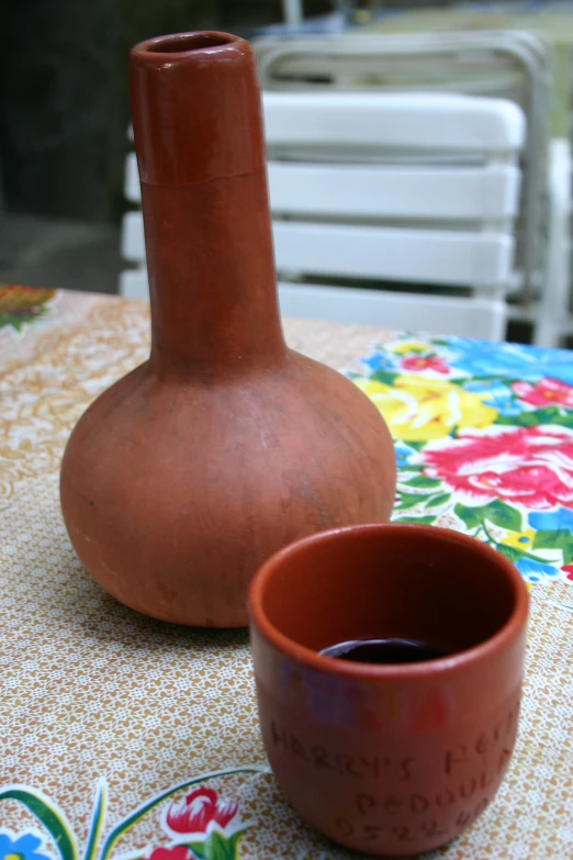 two pots on a table and one has a spoon in it