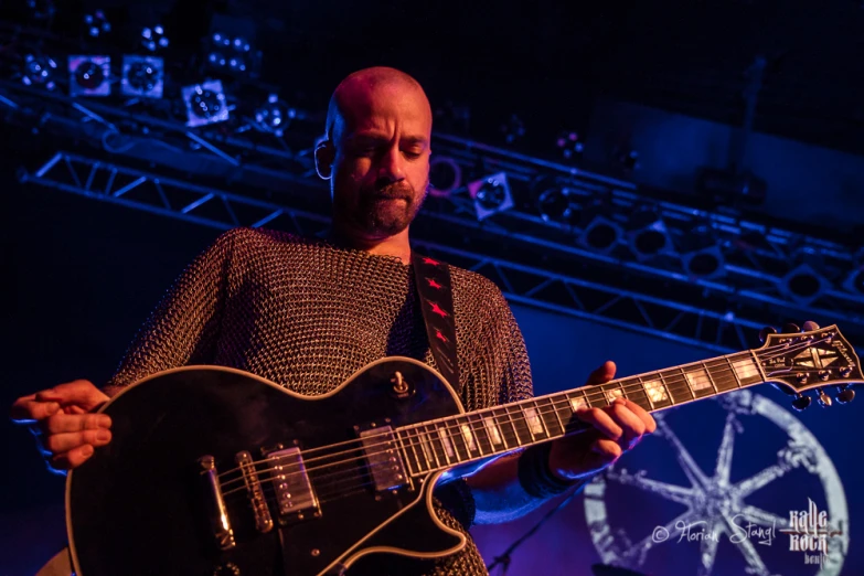 a man plays his electric guitar at the stage