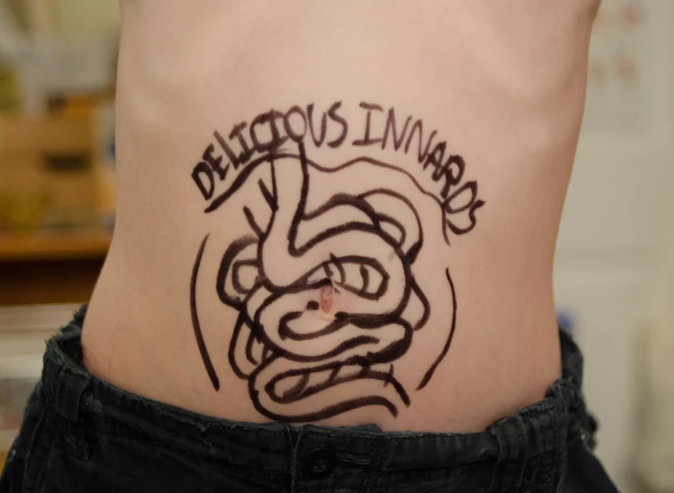 the back of a mans stomach, has been drawn with ink