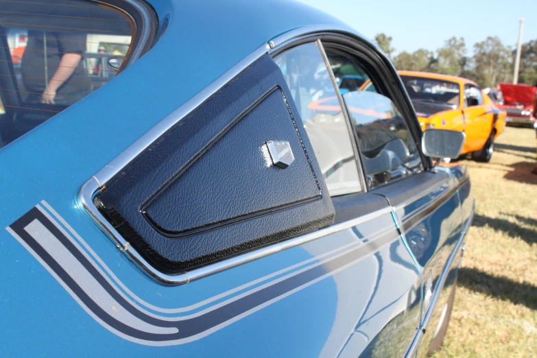 some cars in line at a car show with the back door closed