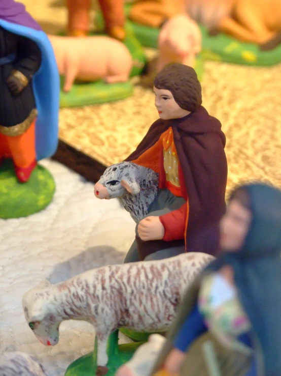 a nativity scene with figurines of sheep and shepherd