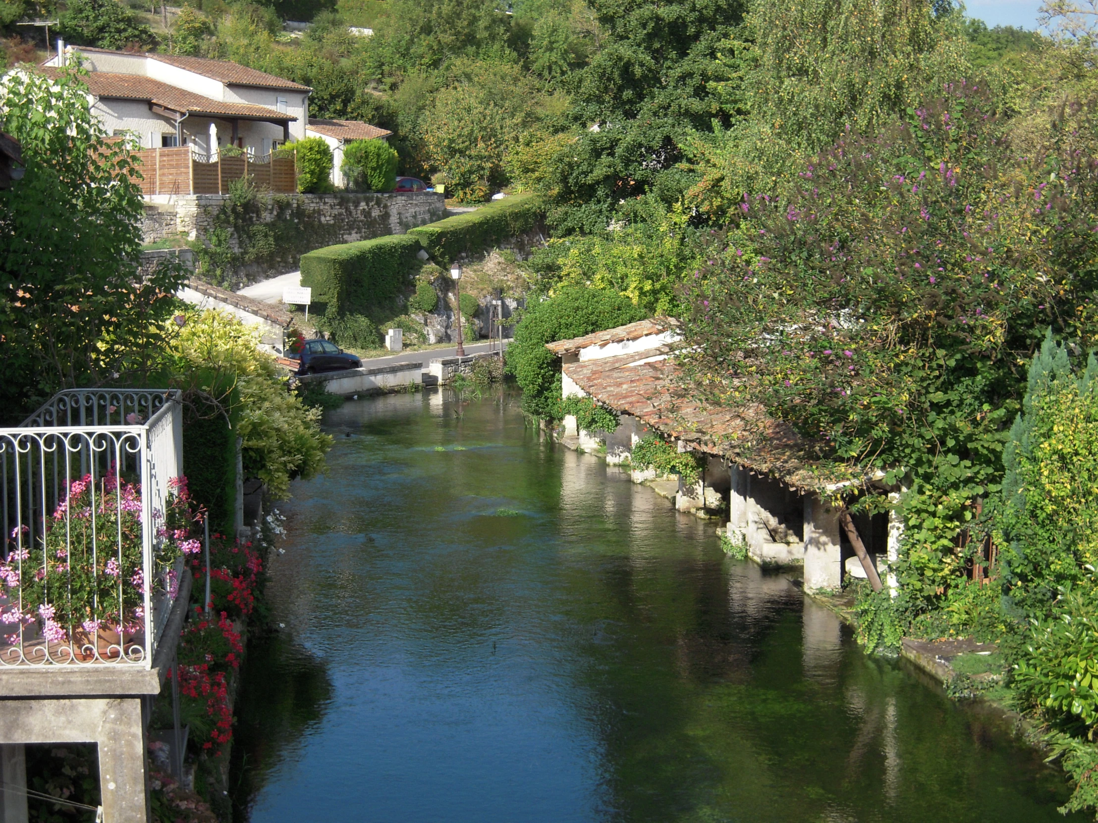 river that runs through a small village with houses on either side