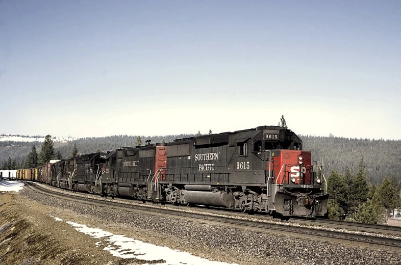 a train engine carrying several carts across a track