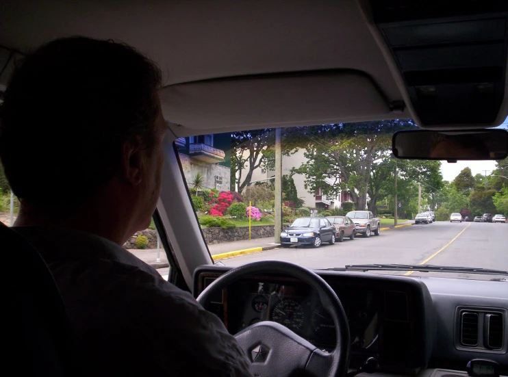 a person is driving down a road with several cars