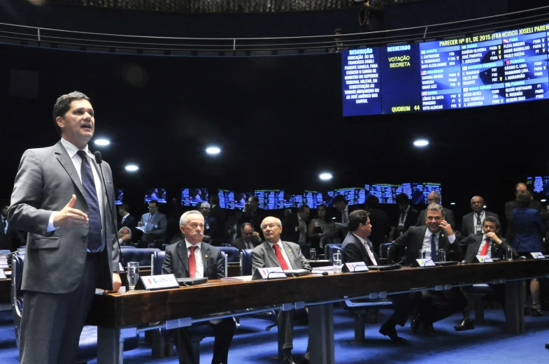 a business meeting room with a speaker and a large board