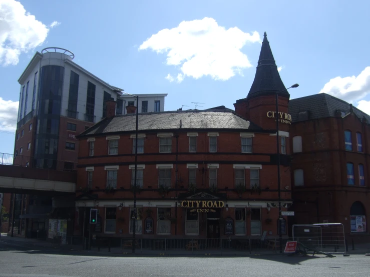 large brick building with roof and many windows on the top of it