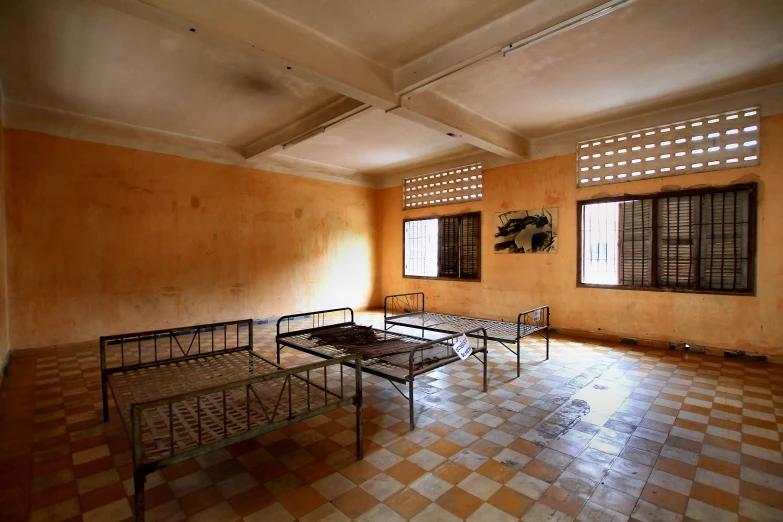 four beds in an old bedroom that is dirty