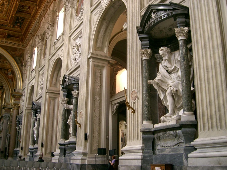 an old po of a very ornate church with statues on the wall