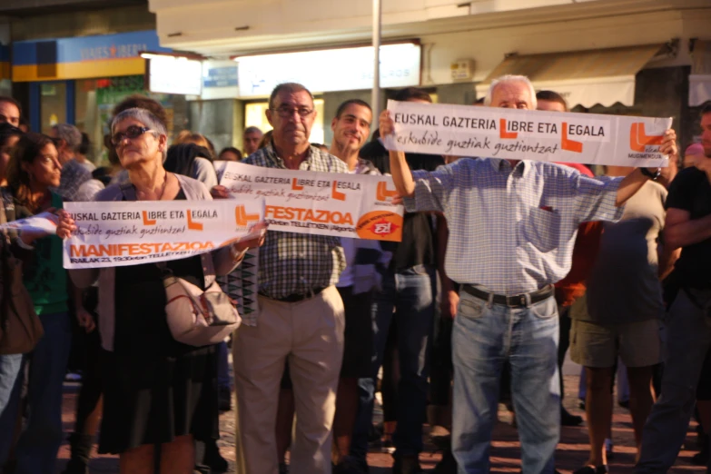 some people standing in a line holding up signs