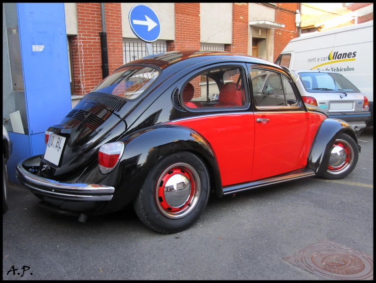 an old volkswagen bug parked on the side of the road