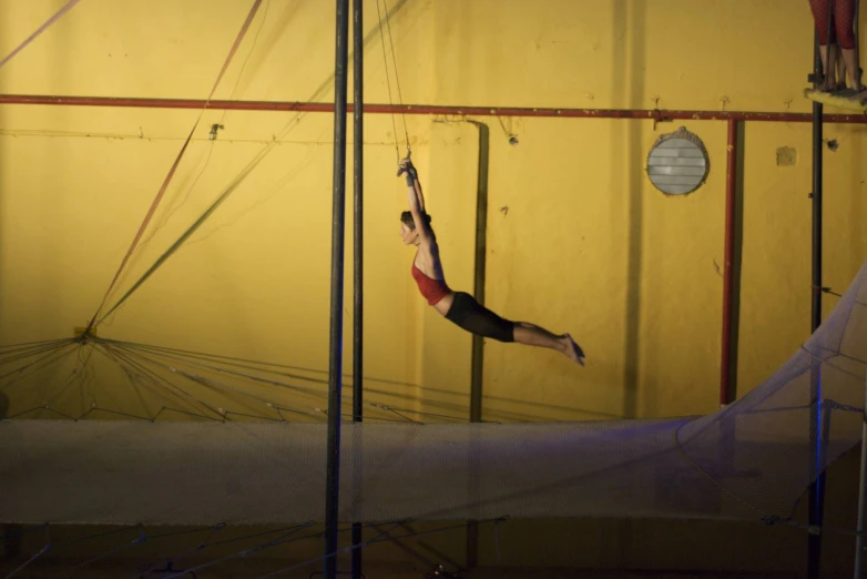 a man is performing a tighty back flip