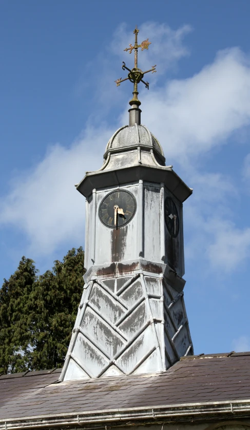 a clock tower with a weather vein on the top