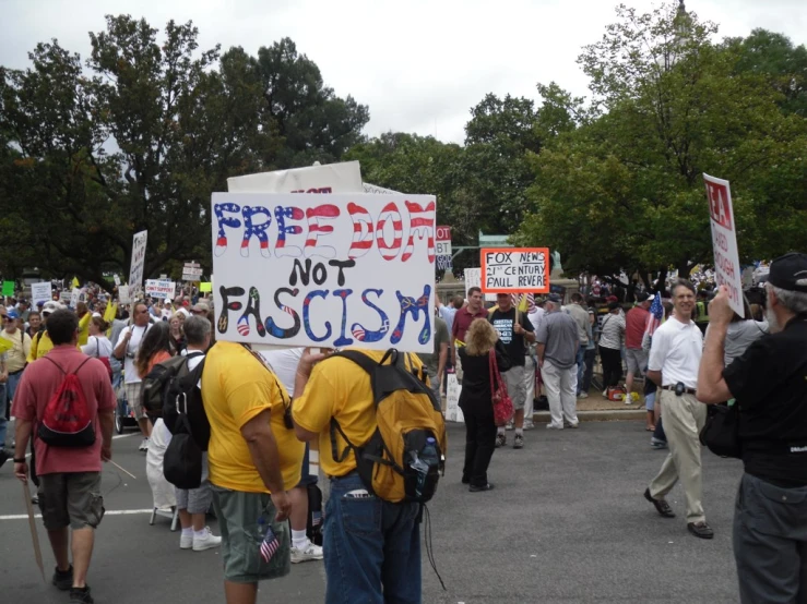 people with yellow shirts protesting in the street