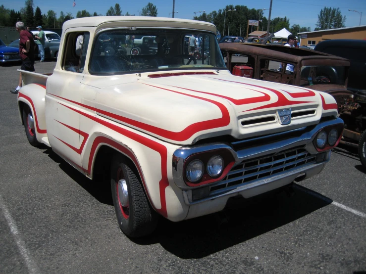 a car with red and white paint job parked in a parking lot