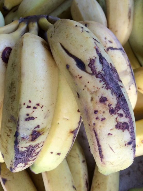 a bunch of bananas with some peeling on them