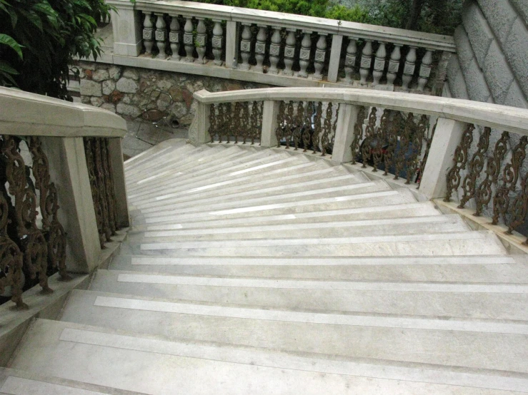 a white marble stair and railings leading to a house