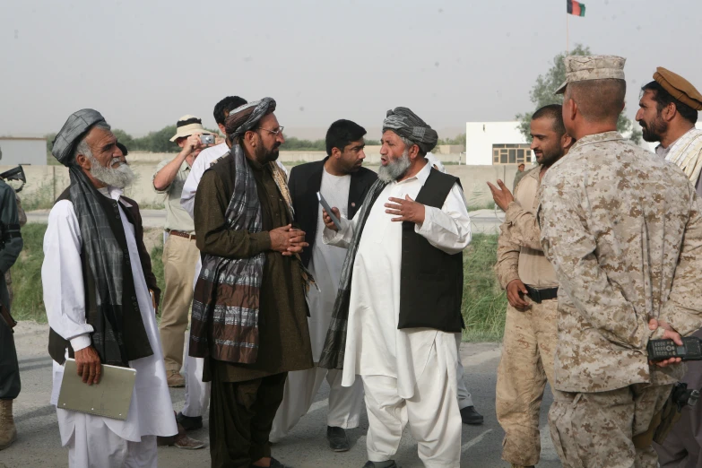 men in uniform having a conversation at the desert