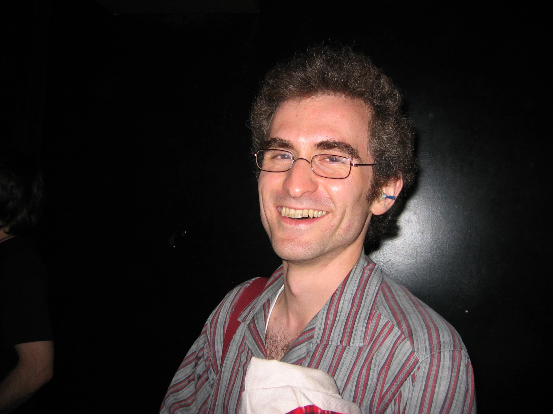 a man smiles as he waits to be served food