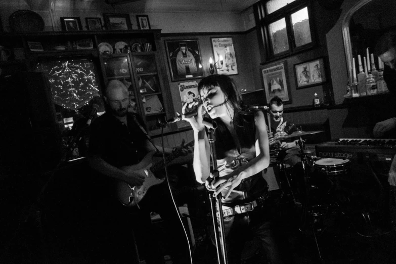 woman playing instruments in the middle of a bar