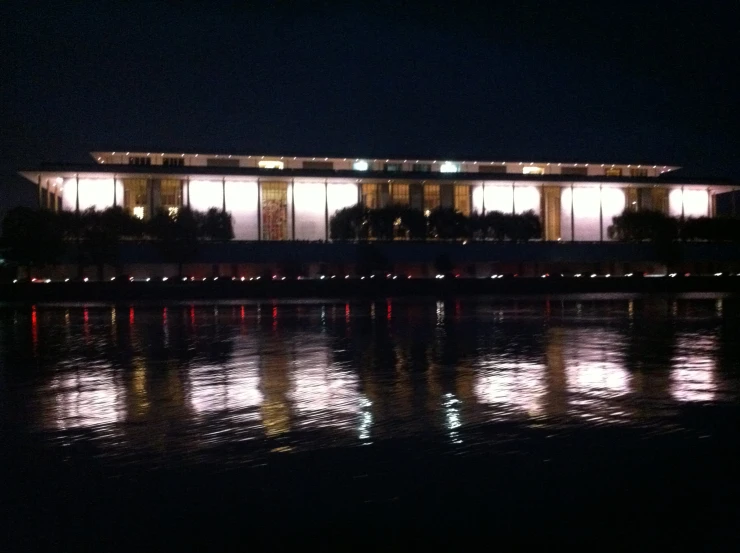 buildings lit up in night by the water