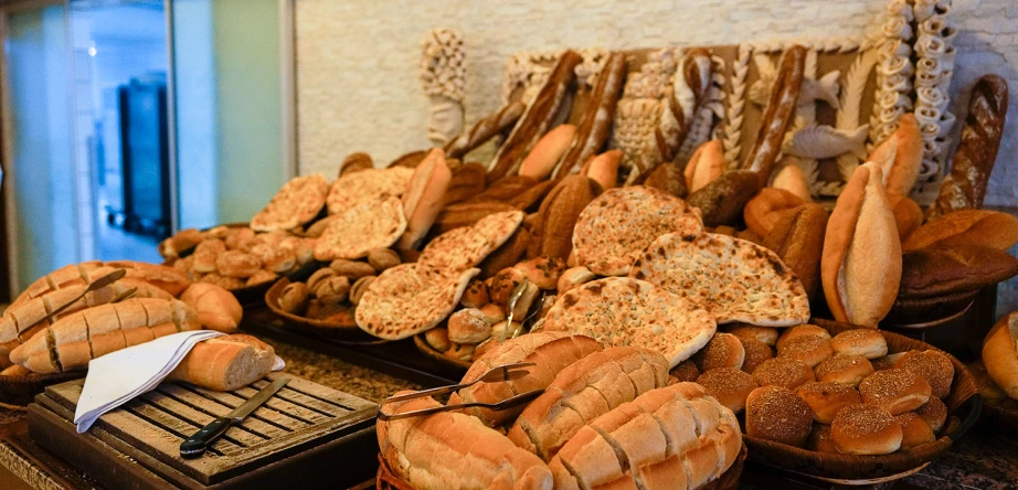 a table topped with lots of loafs and loaves of bread