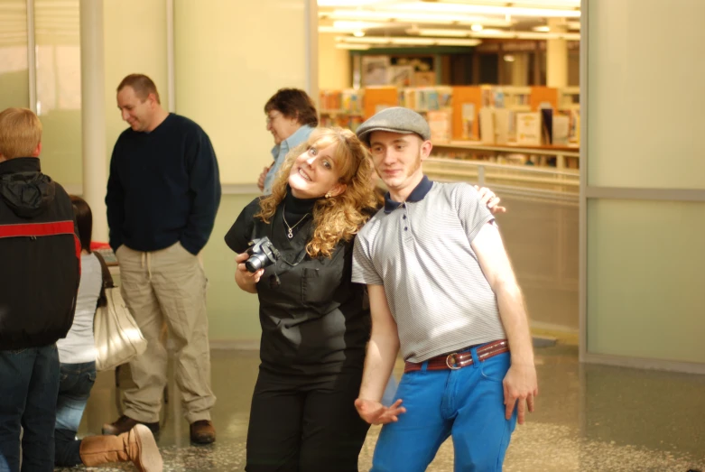 a boy and girl are smiling with arms around each other