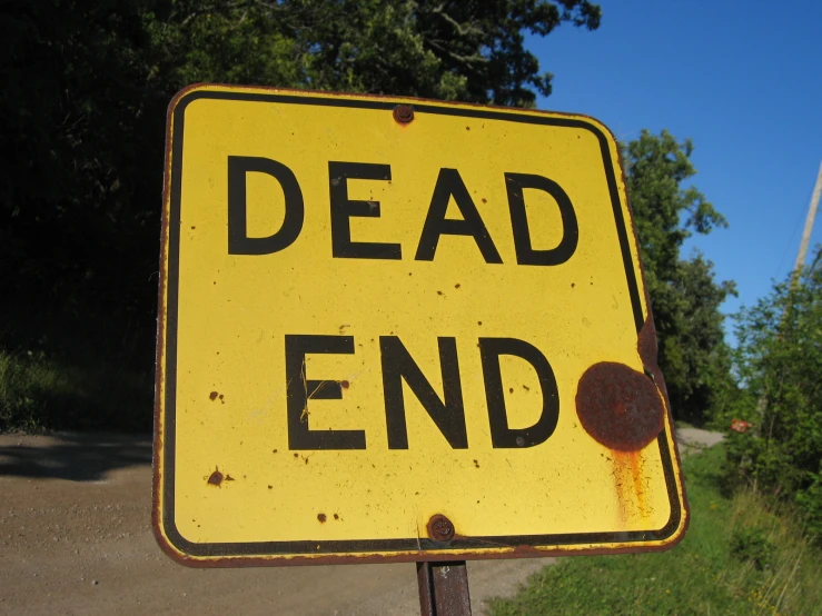 an upside down street sign reading dead end