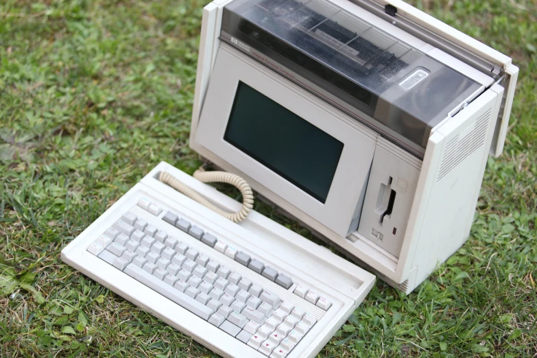 a small computer is laying on the ground