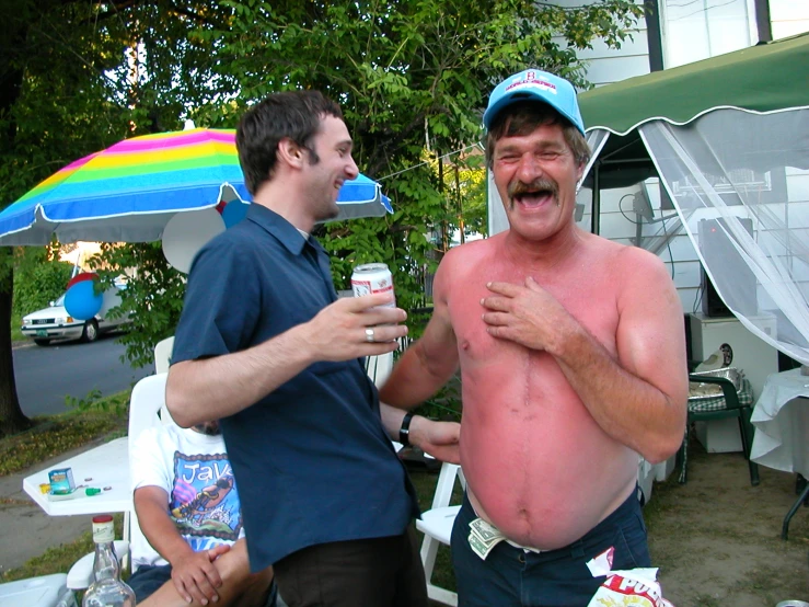 a man in a shirt that has a beer next to another person