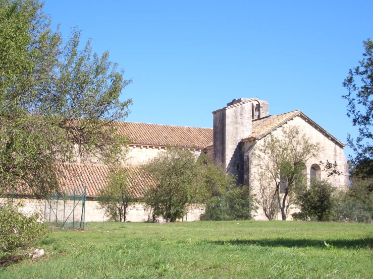 a church with a brown roof surrounded by trees