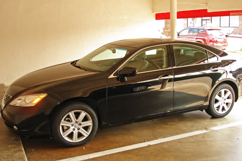 a black car is sitting in an empty spot