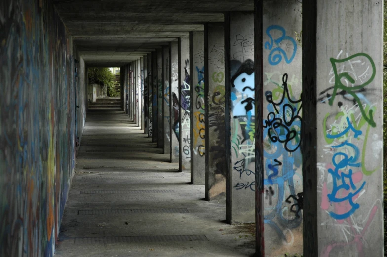 there are several graffiti walls lined up along a long hallway