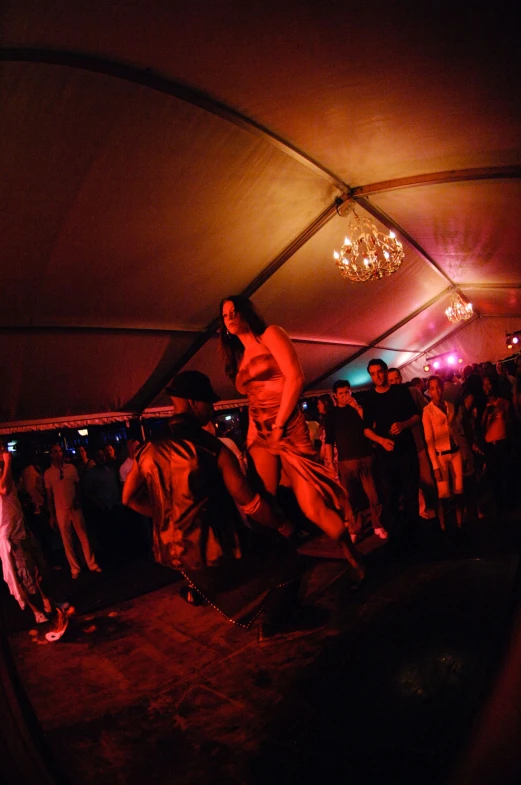 the people in the tent are dancing under their canopy