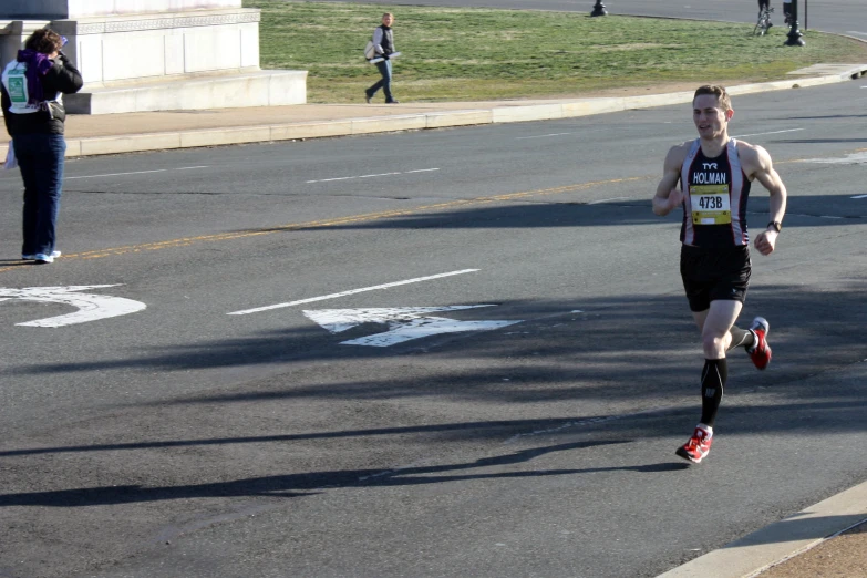 the male runner is starting his run in the street